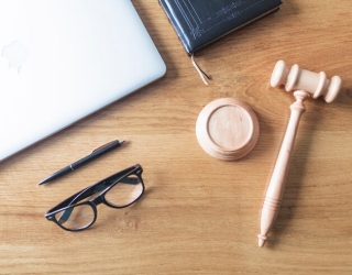 high-angle-view-laptop-spectacles-gavel-pen-wooden-background-wooden-desk_23-2147876787